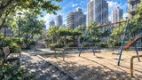 ビル群を背景にした公園の遊具と影（ノスタルジー）